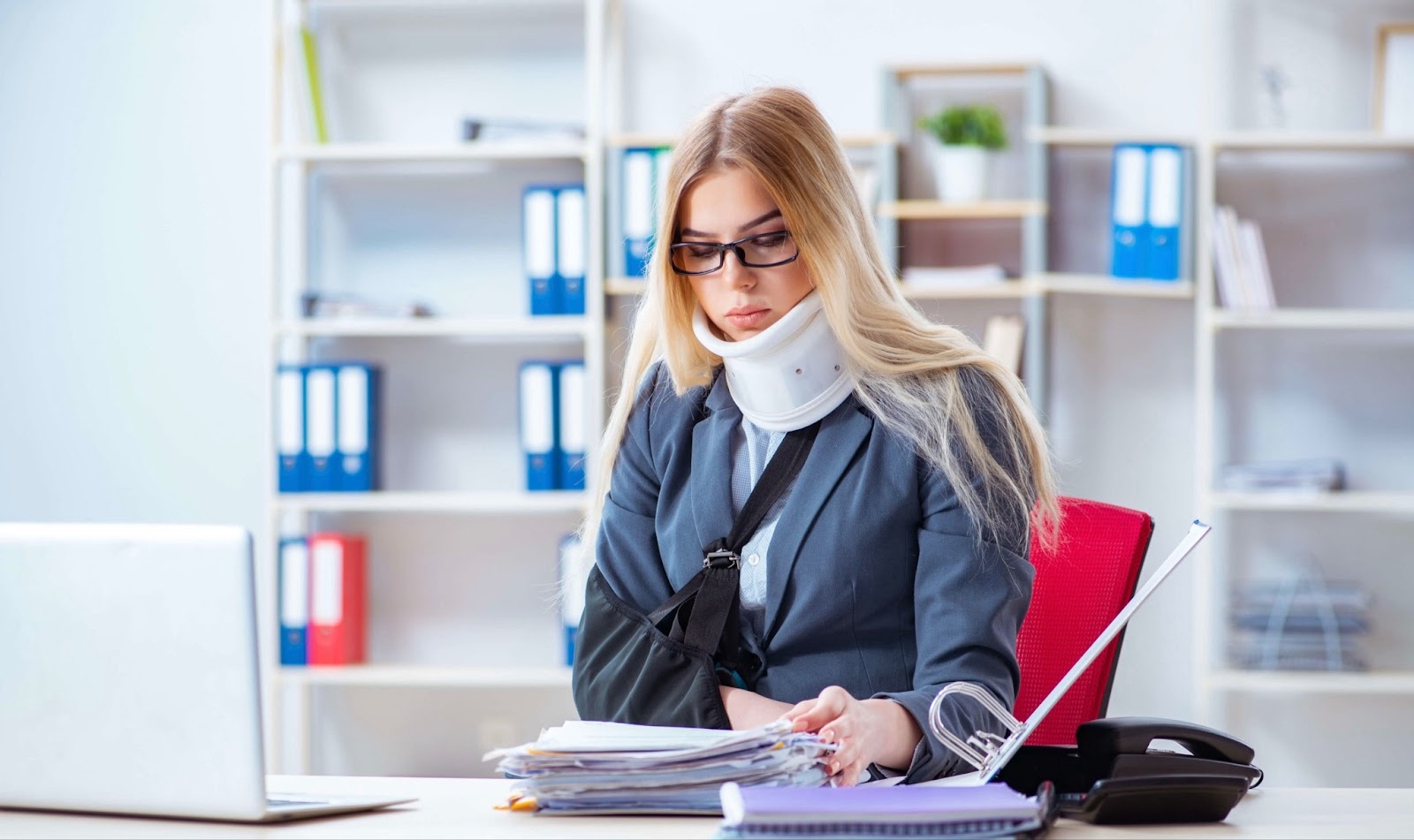 Girl with a cast on her arm and neck in the office