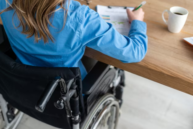 Girl in a wheelchair signs documents