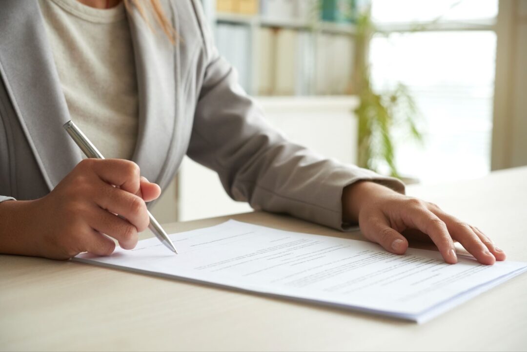 Close up of woman signing the document